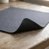Close-up of the kitchen counter mat corner showing the fabric top and non-slip rubber base